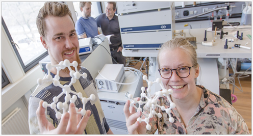 PhD student Mikkel Agerbæk Sørensen from the Department of Chemistry and Postdoc Ursula Bengård Hansen from the research group X-ray and Neutron Science at the Niels Bohr Institute shows a 3D model of the studied molecule. By making small changes in the form of the molecule, the tunnelling can be suppressed. In the background Associate Professor Kim Lefmann and Professor Jesper Bendix. Photo: Ola J. Joensen