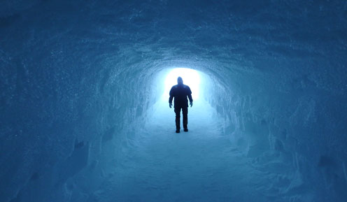 Man in ice tunnel