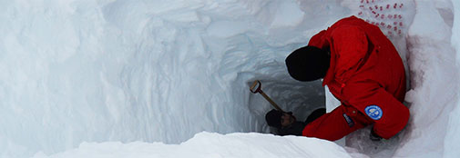 Looking into a mining shaft of the ice cap. Andrea keeping track of sample beakers at 2m depth and Niccoló sampling at 4m depth (yesterday).