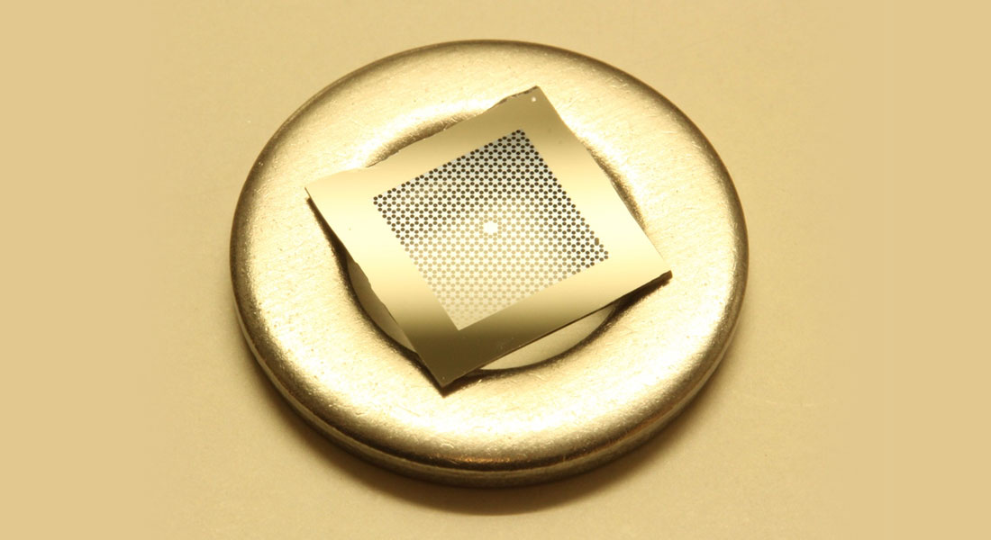 An ultra-coherent phononic crystal membrane resonator, with a M6 spacer for scale.