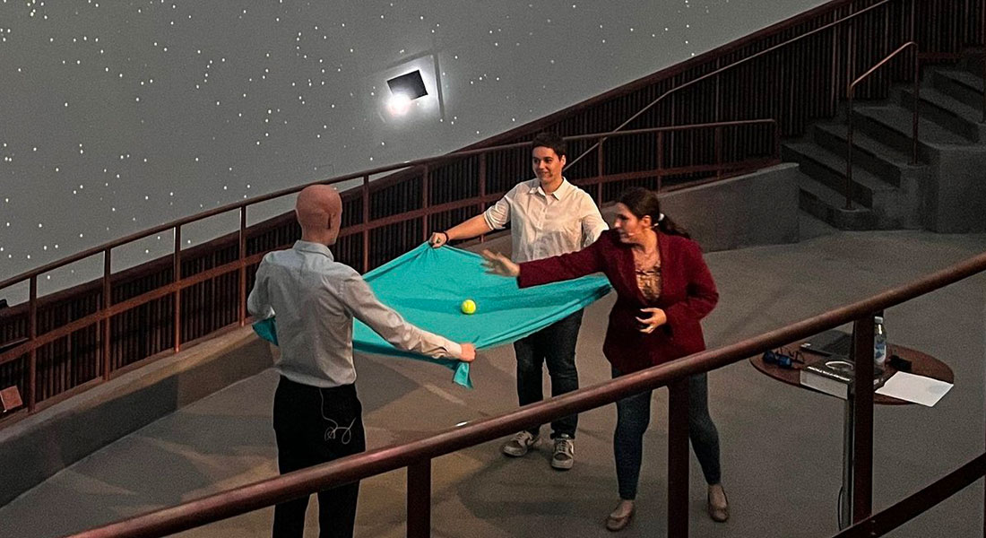 Leart Sabani, Lucía Vélez Tartajo and Ariadna Ribes Metidieri demonstrating how mass curves spacetime, at the Tycho Brahe Planetarium in Copenhagen.